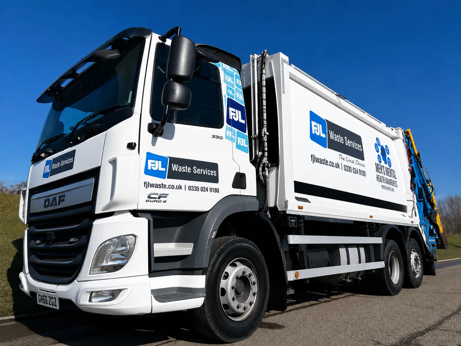 A white FJL Waste Services DAF bin lorry with blue FJL branding and a Men's Mental Health Awareness panel on the side, photographed against a clear blue sky.
